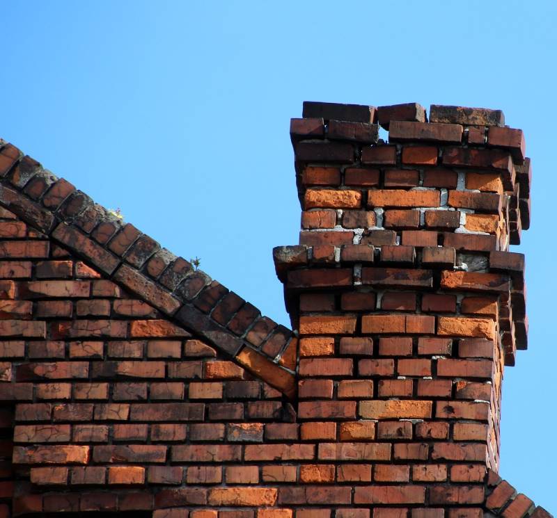Damaged chimney on an Oak Lawn home showing cracks and missing mortar
